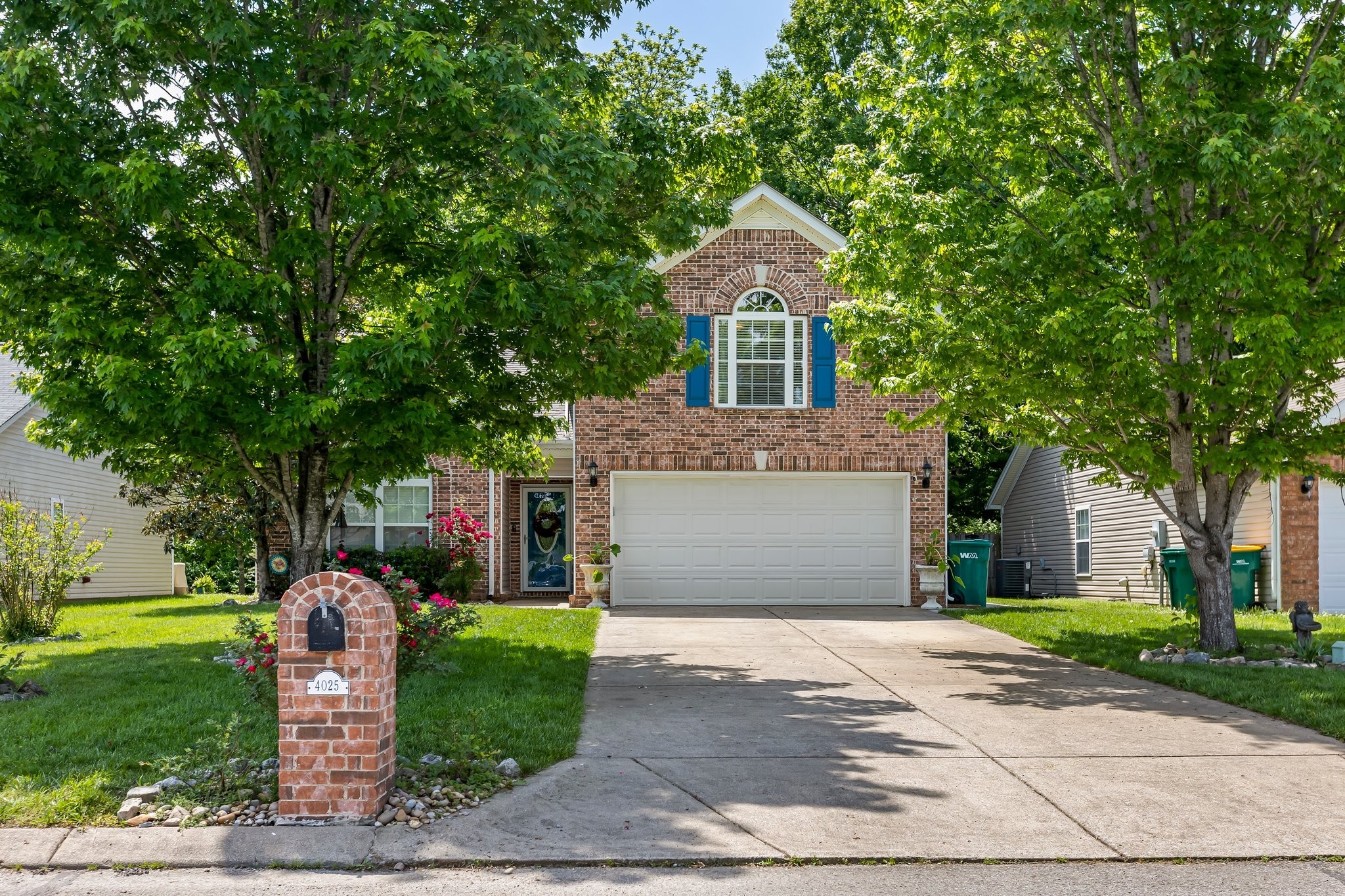 4025 Deer Run Trace Spring Hill, TN 37174 - Photo 2 of 54 a front view of a house with a garden and plants