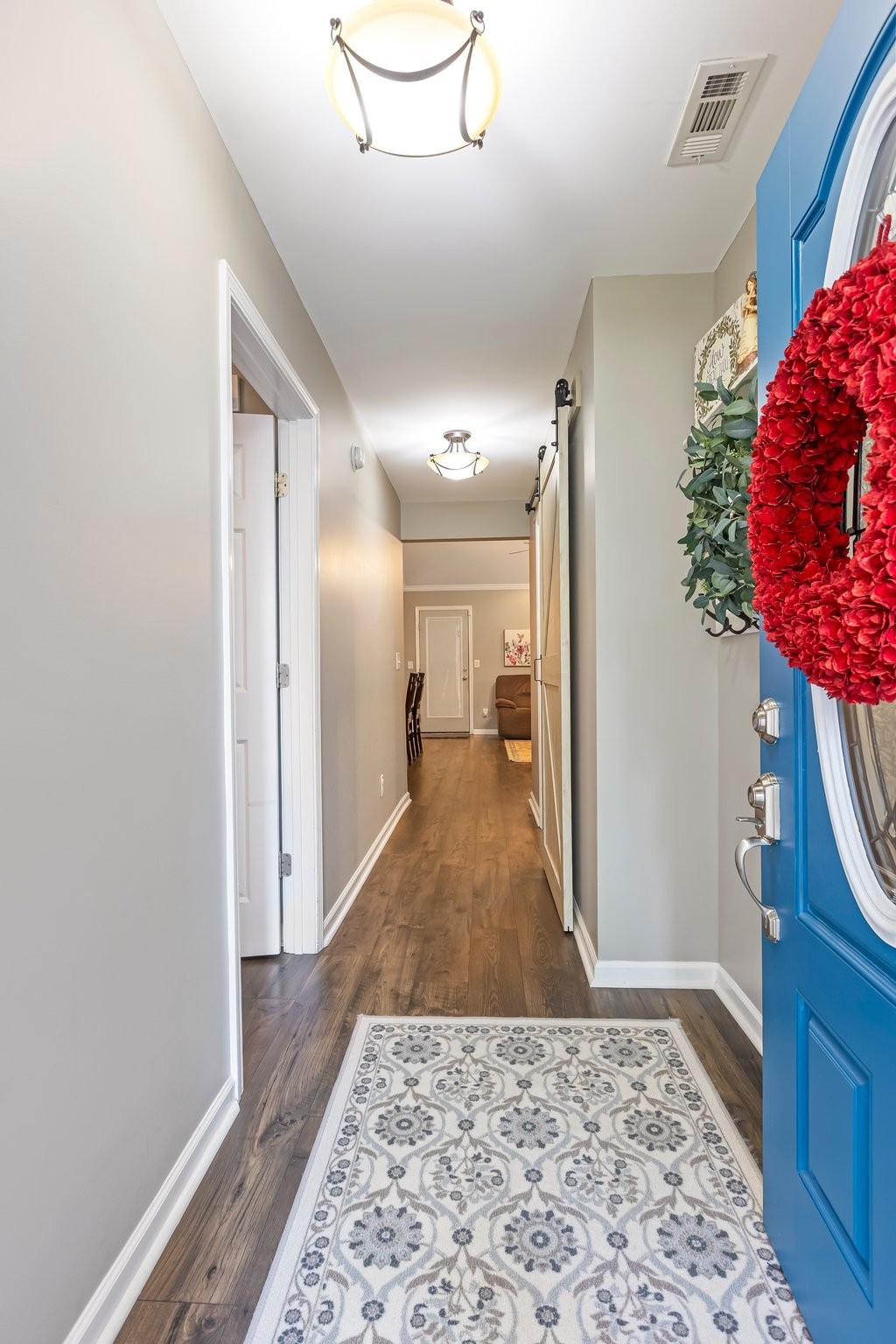 4025 Deer Run Trace Spring Hill, TN 37174 - Photo 3 of 54 a view of a hallway with wooden floor and a rug