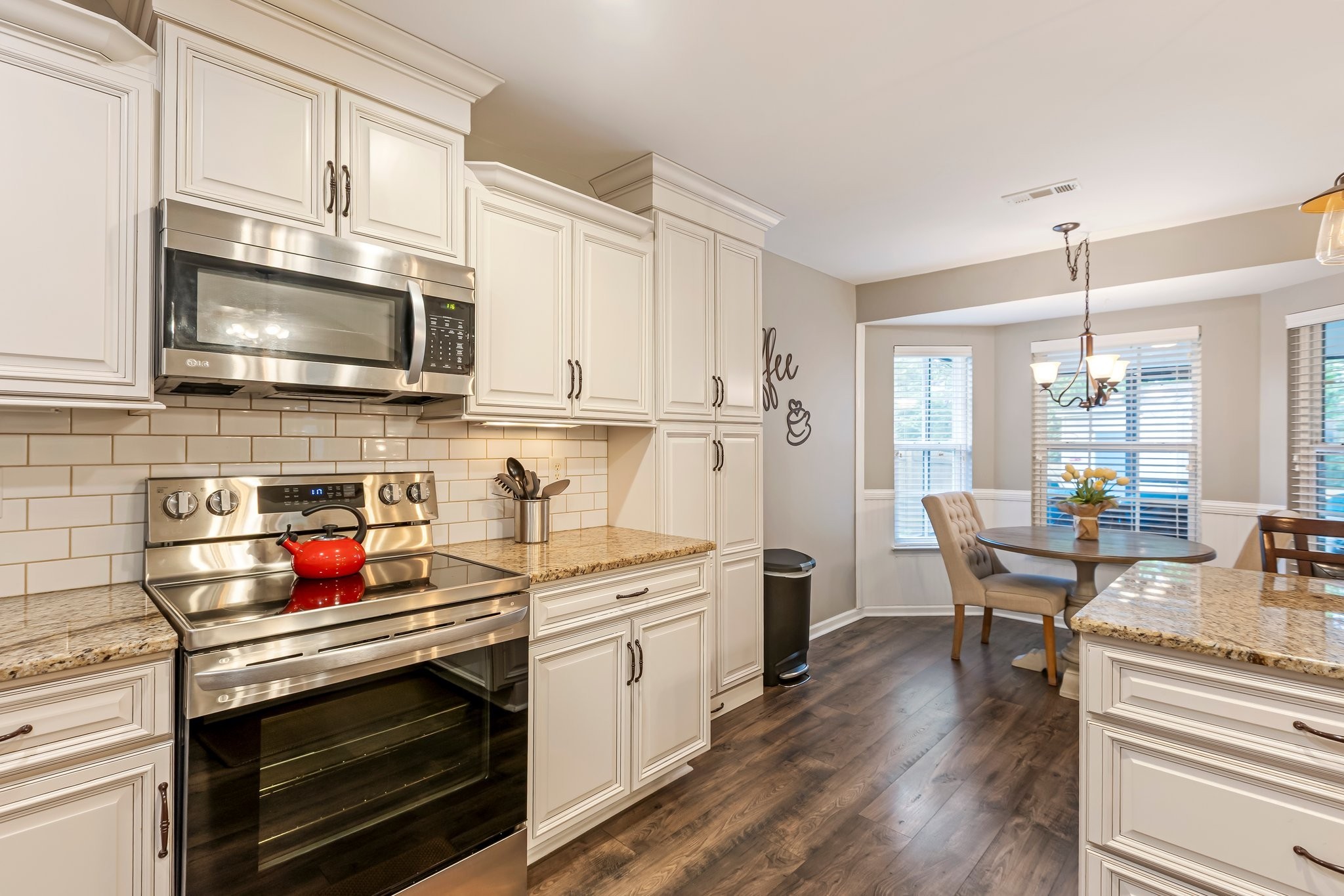 4025 Deer Run Trace Spring Hill, TN 37174 - Photo 8 of 54 a kitchen with stainless steel appliances a stove sink microwave and cabinets