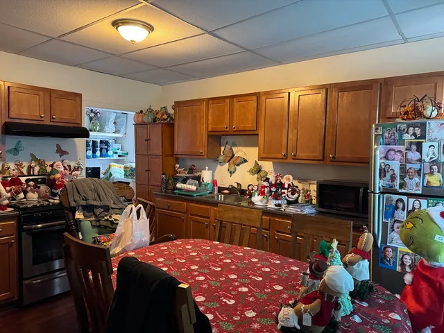 a kitchen filled with a dining table chairs and a stove