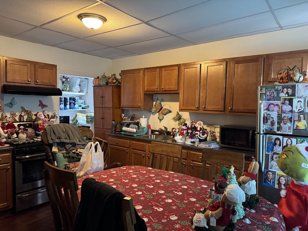 289 Chelsea Street Boston, MA 02128 - Photo 12 of 23 a kitchen filled with a dining table chairs and a stove