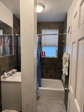 a bathroom with a bathtub a sink and a shower