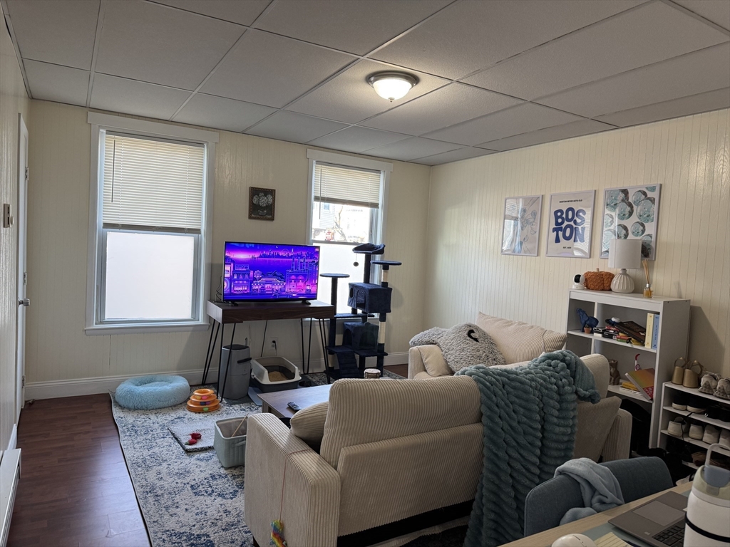289 Chelsea Street Boston, MA 02128 - Photo 4 of 23 a living room with furniture and a flat screen tv