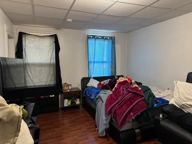 a bedroom with a bed and a mirror