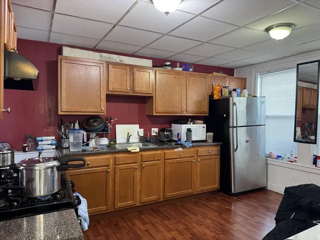 a kitchen with sink a refrigerator and cabinets