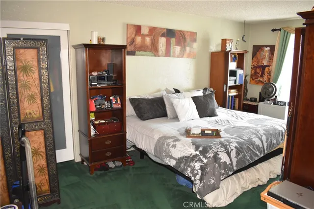 a bedroom with a bed and a flat tv screen