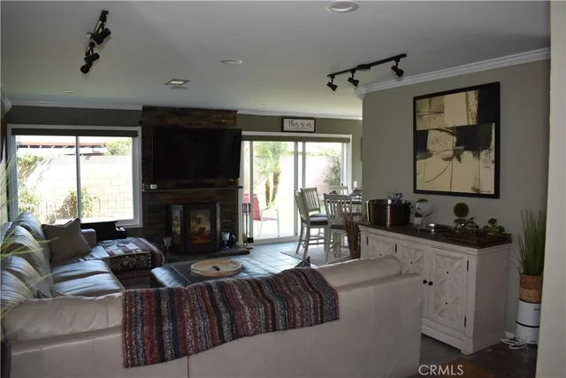 a living room with furniture a large window and a fireplace