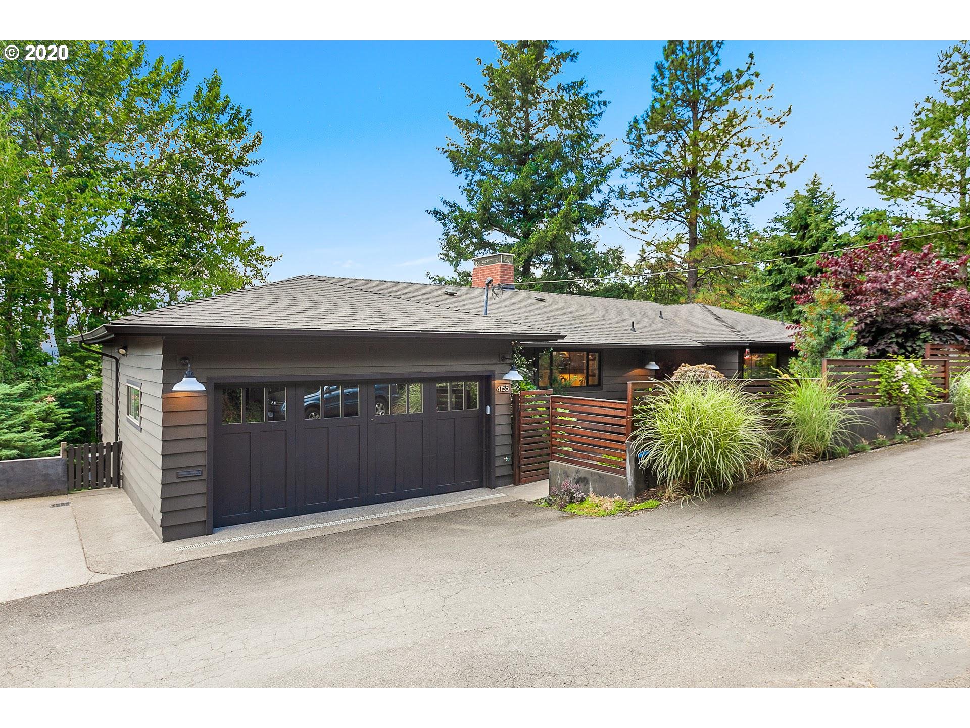 4155 Southwest Agate Lane Portland, OR 97239 - Photo 1 of 32 a front view of a house with a yard and garage