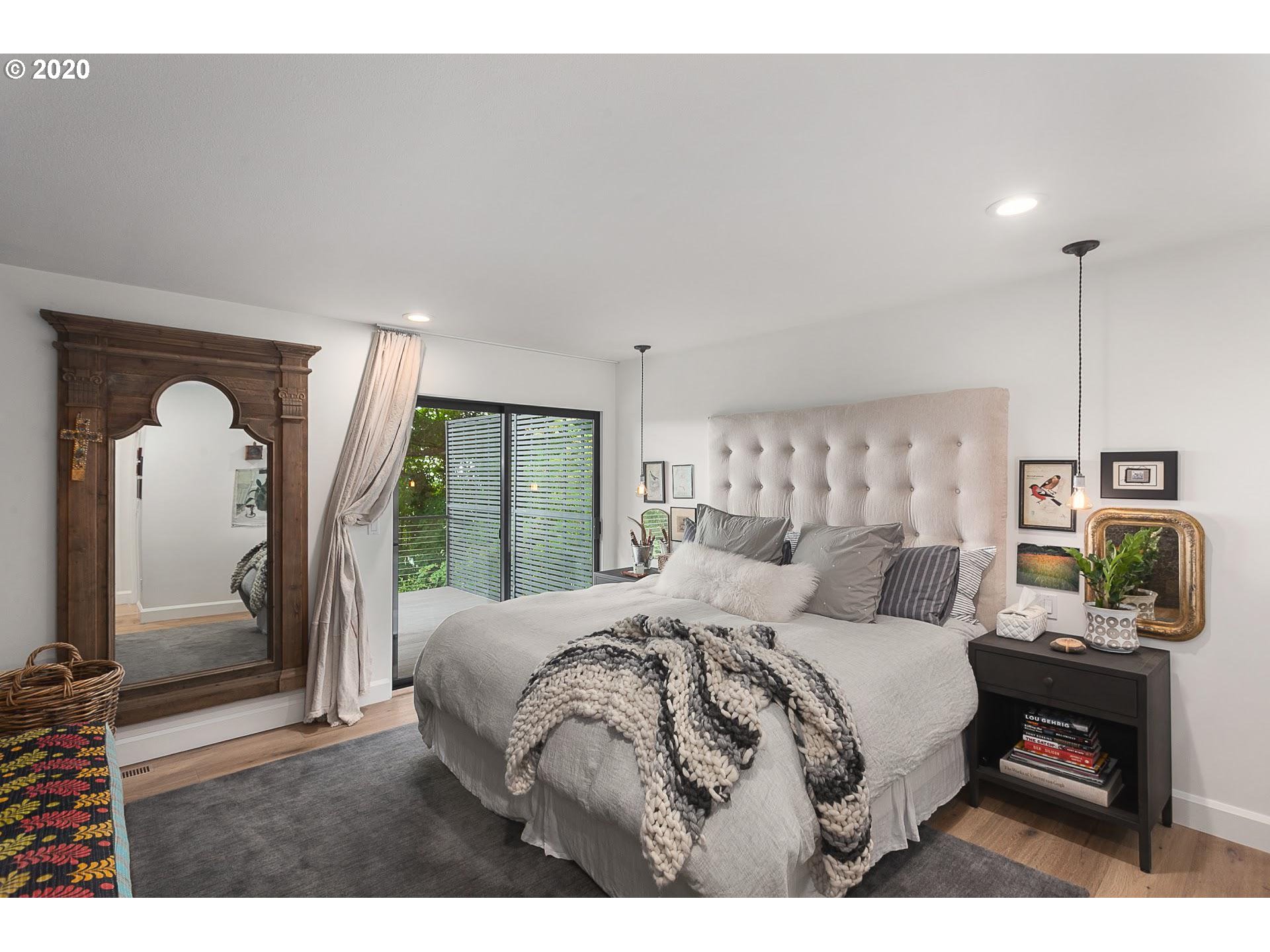 4155 Southwest Agate Lane Portland, OR 97239 - Photo 19 of 32 a bedroom with a bed window and wall painting
