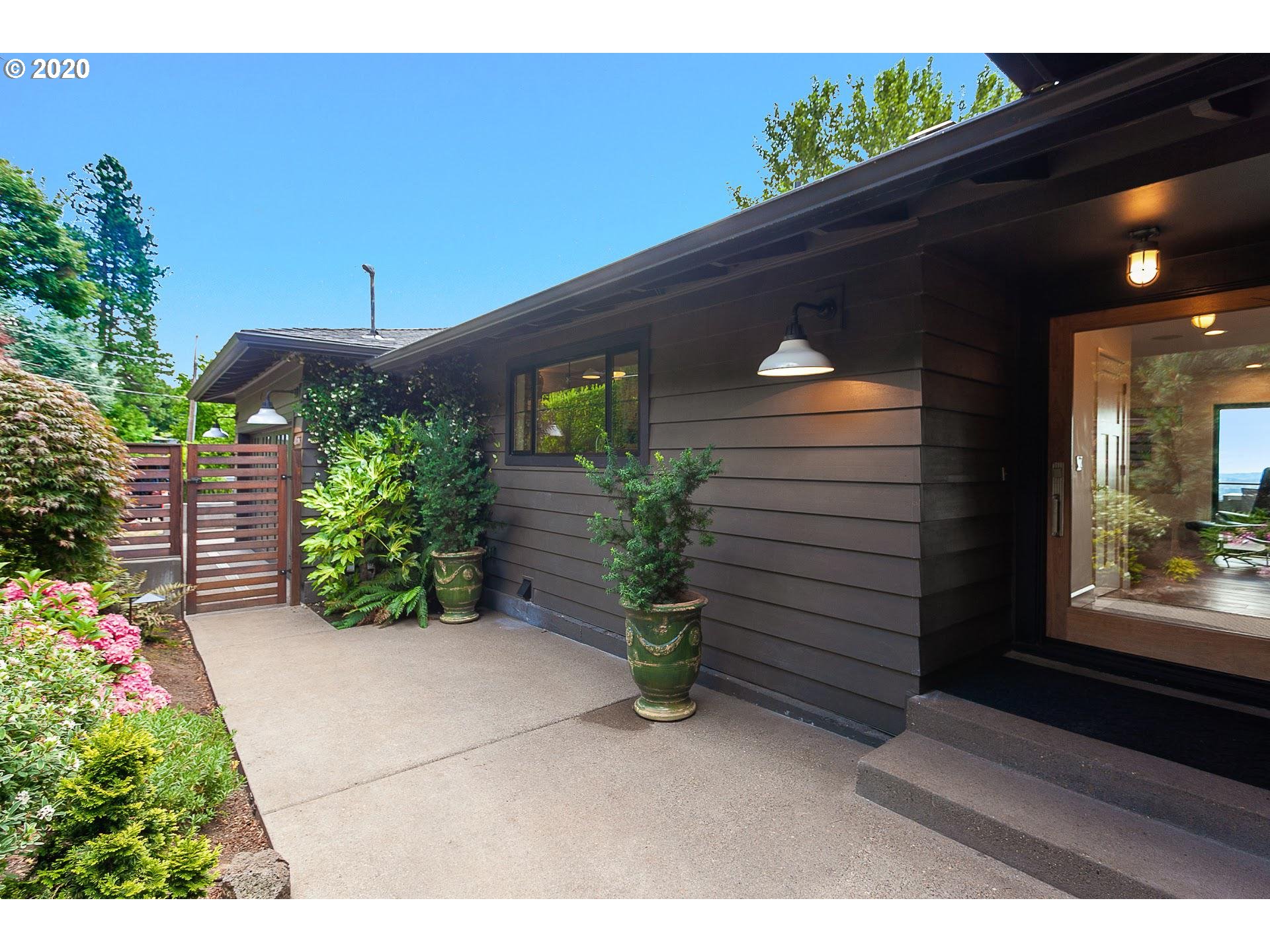 4155 Southwest Agate Lane Portland, OR 97239 - Photo 3 of 32 a front view of a house with a yard