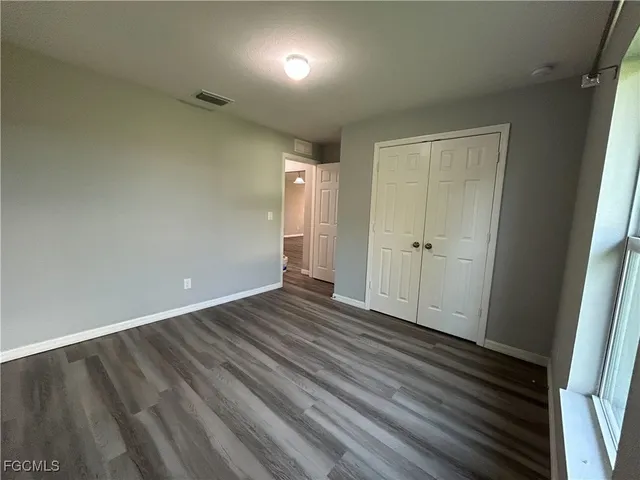 a view of an empty room and wooden floor