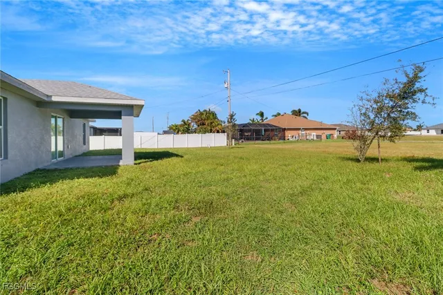 a view of a big room with an ocean and trees