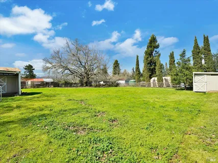 a view of an house with backyard space and garden
