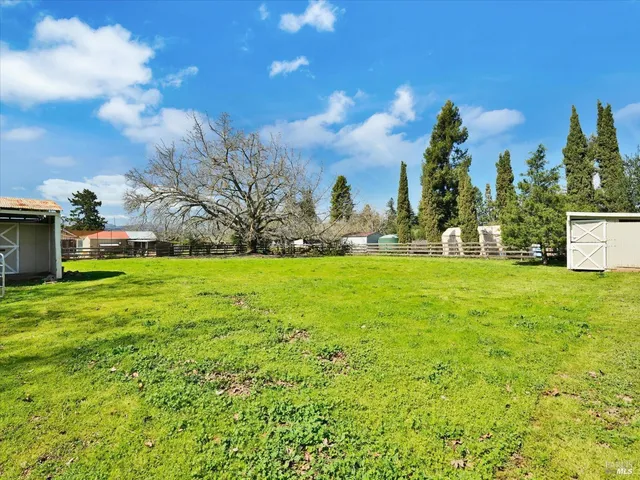 a view of an house with backyard space and garden
