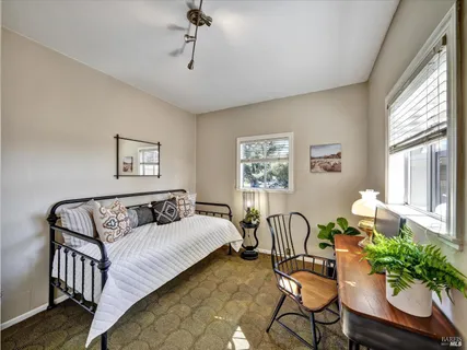 a bedroom with furniture and a window