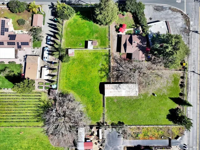an aerial view of a house with a yard and garden