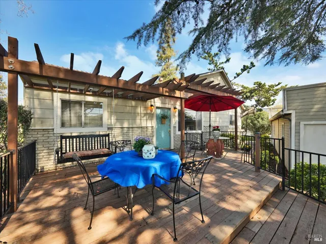a view of a chairs and table in patio with a fire pit