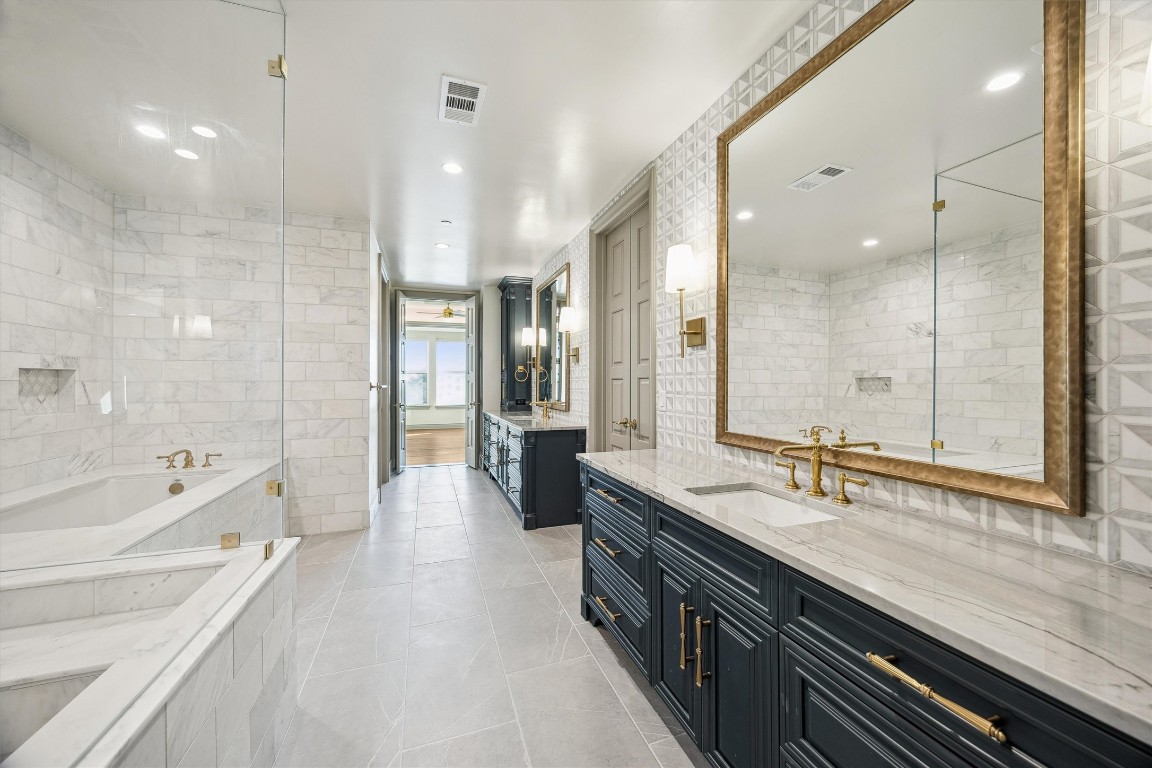 1717 Bissonnet Street, Unit 1802 Houston, TX 77005 - Photo 17 of 46 Luxurious primary bathroom with separate vanities.