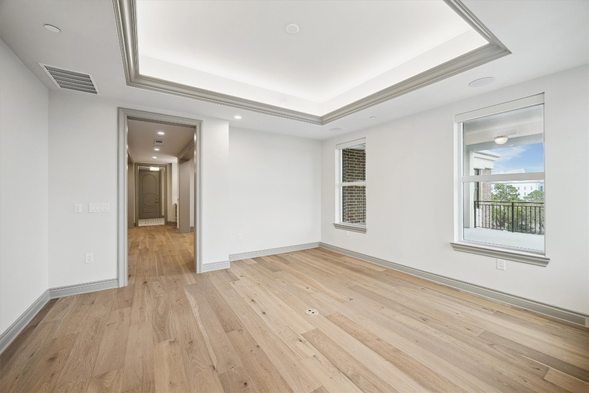 1717 Bissonnet Street, Unit 1802 Houston, TX 77005 - Photo 24 of 46 a view of an empty room with wooden floor and a window