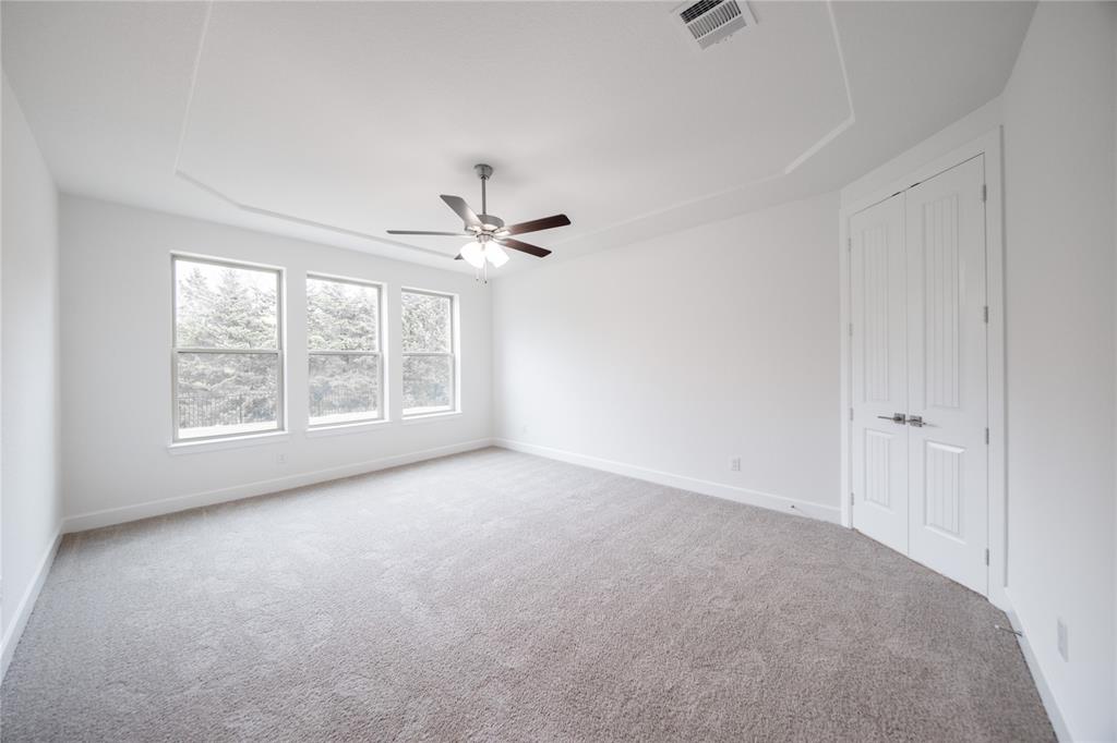 3807 Majesty Court Forney, TX 75126 - Photo 11 of 37 a view of an empty room with windows and chandelier fan