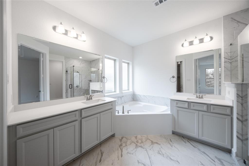 3807 Majesty Court Forney, TX 75126 - Photo 13 of 37 a bathroom with a double vanity sink mirror and bathtub