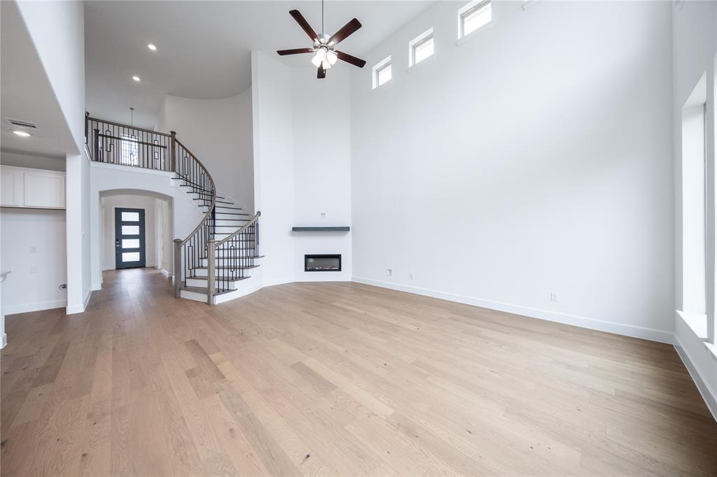 3807 Majesty Court Forney, TX 75126 - Photo 8 of 37 an empty room with wooden floor fan and windows