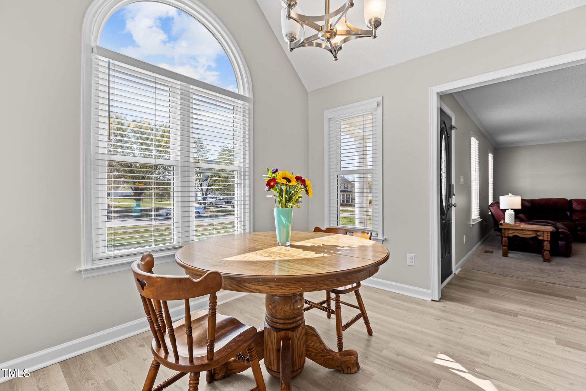 1408 Harvey Johnson Road Raleigh, NC 27603 - Photo 13 of 48 a view of a dining room with furniture and wooden floor