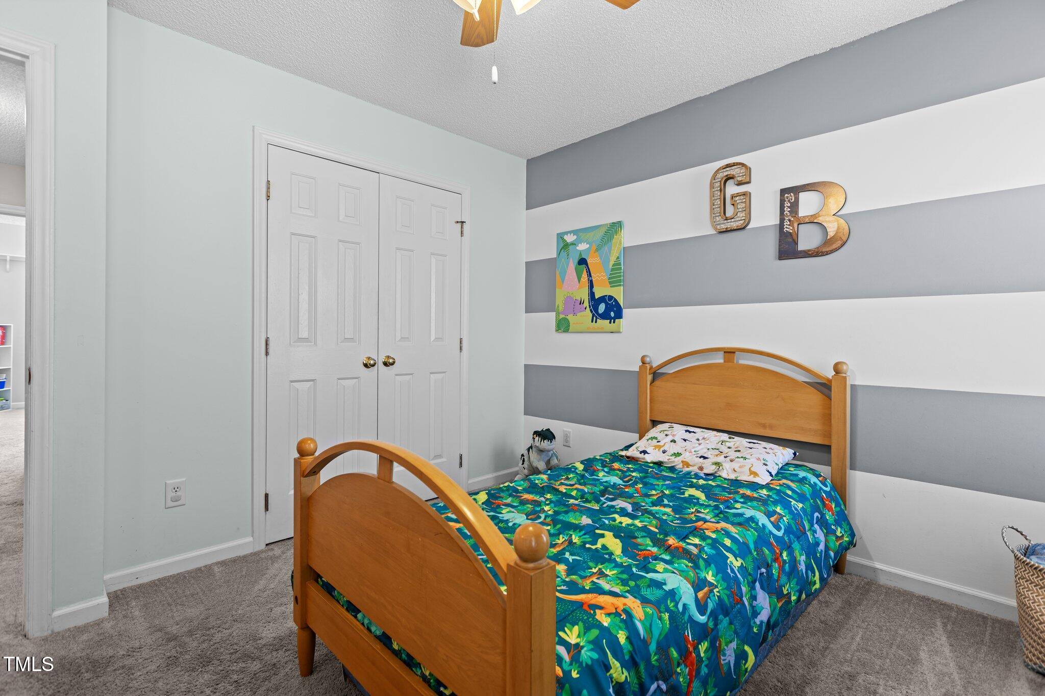 1408 Harvey Johnson Road Raleigh, NC 27603 - Photo 25 of 48 a bedroom with a bed a dresser and potted plant