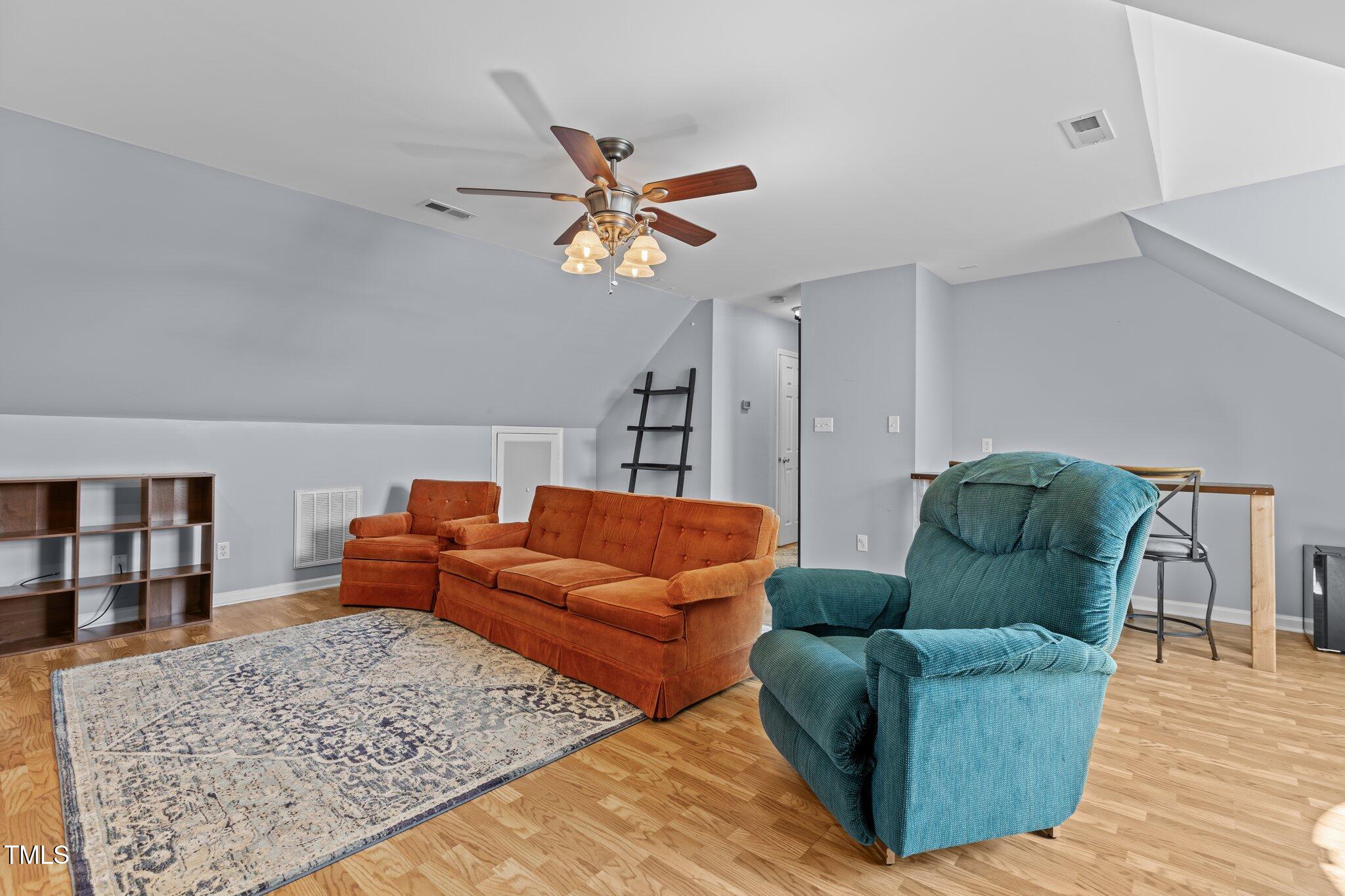 1408 Harvey Johnson Road Raleigh, NC 27603 - Photo 28 of 48 a living room with furniture wooden floor and a rug