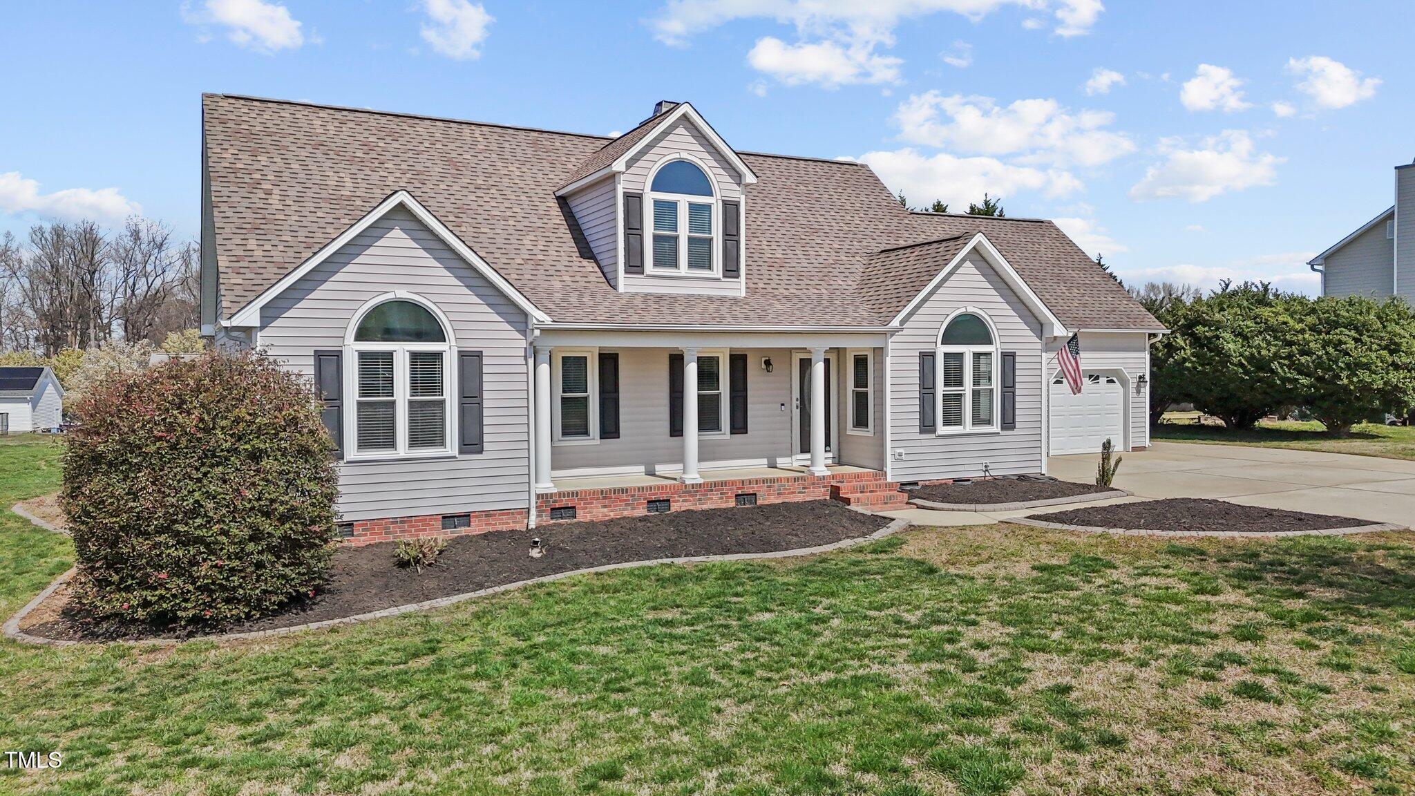 1408 Harvey Johnson Road Raleigh, NC 27603 - Photo 6 of 48 a front view of a house with a yard