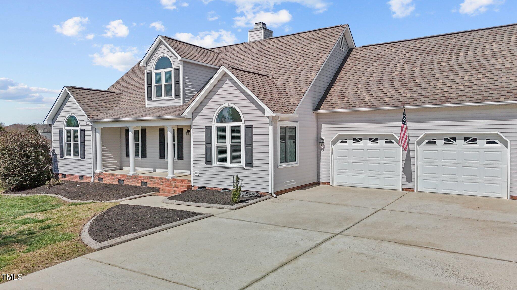 1408 Harvey Johnson Road Raleigh, NC 27603 - Photo 8 of 48 a front view of a house with a garage
