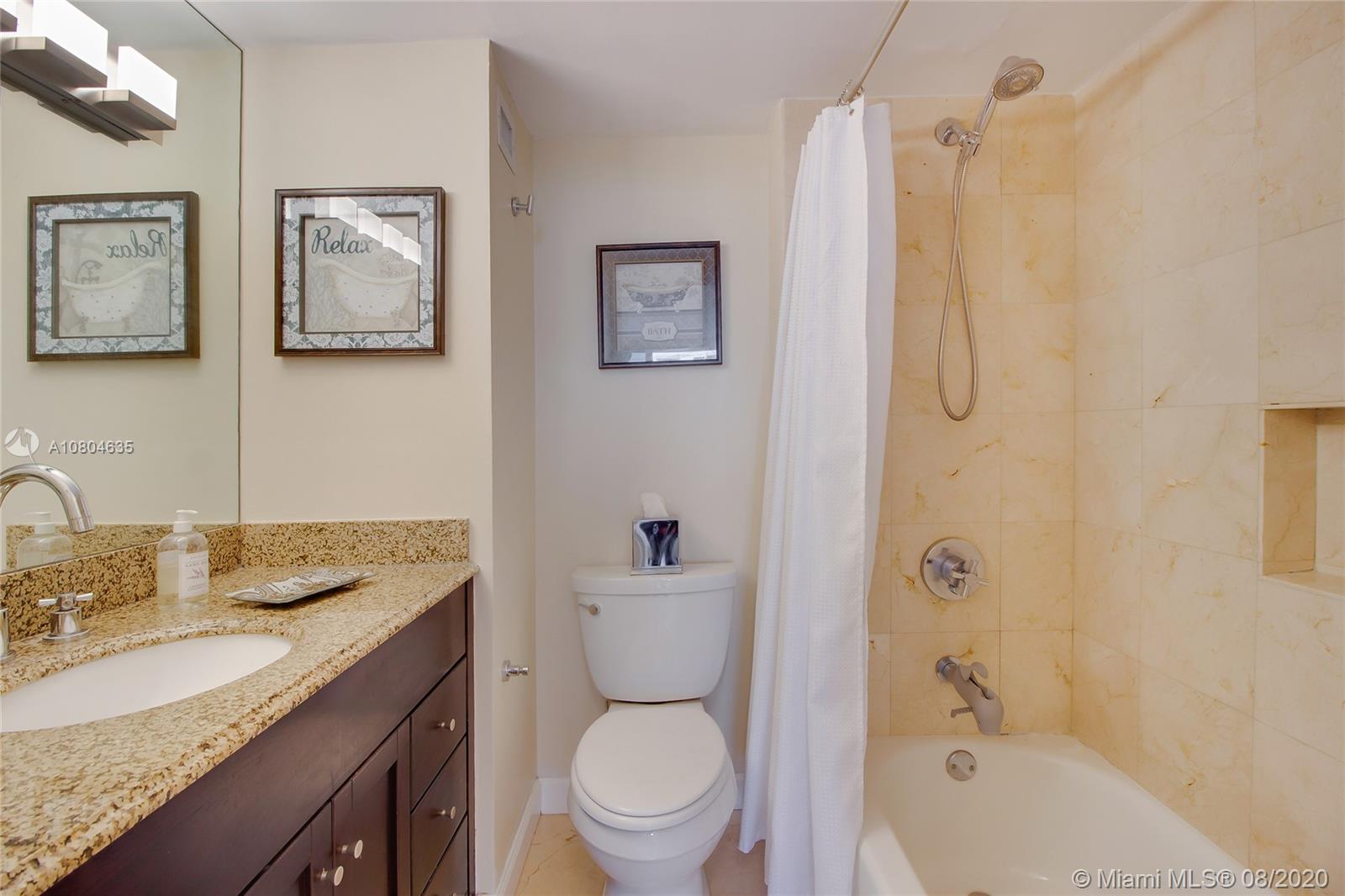 200 Southeast 15th Road, Unit 6D Miami, FL 33129 - Photo 12 of 20 a bathroom with a granite countertop toilet sink and mirror