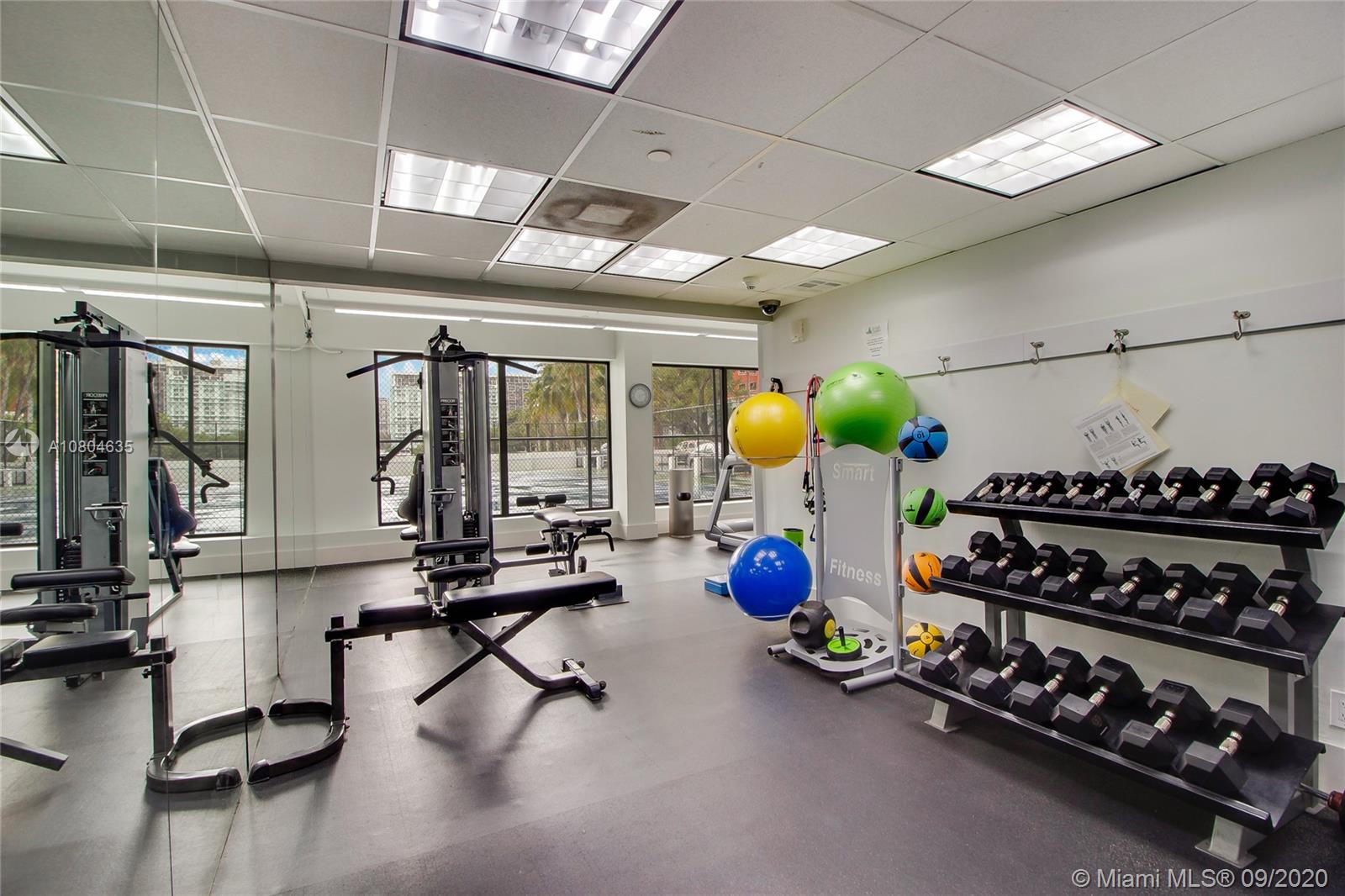 200 Southeast 15th Road, Unit 6D Miami, FL 33129 - Photo 15 of 20 a room with gym equipment and large windows