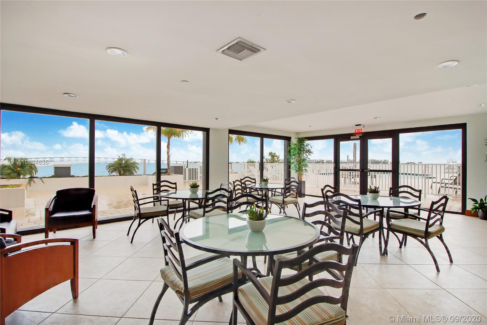 200 Southeast 15th Road, Unit 6D Miami, FL 33129 - Photo 16 of 20 a view of a dining room with furniture large windows and wooden floor