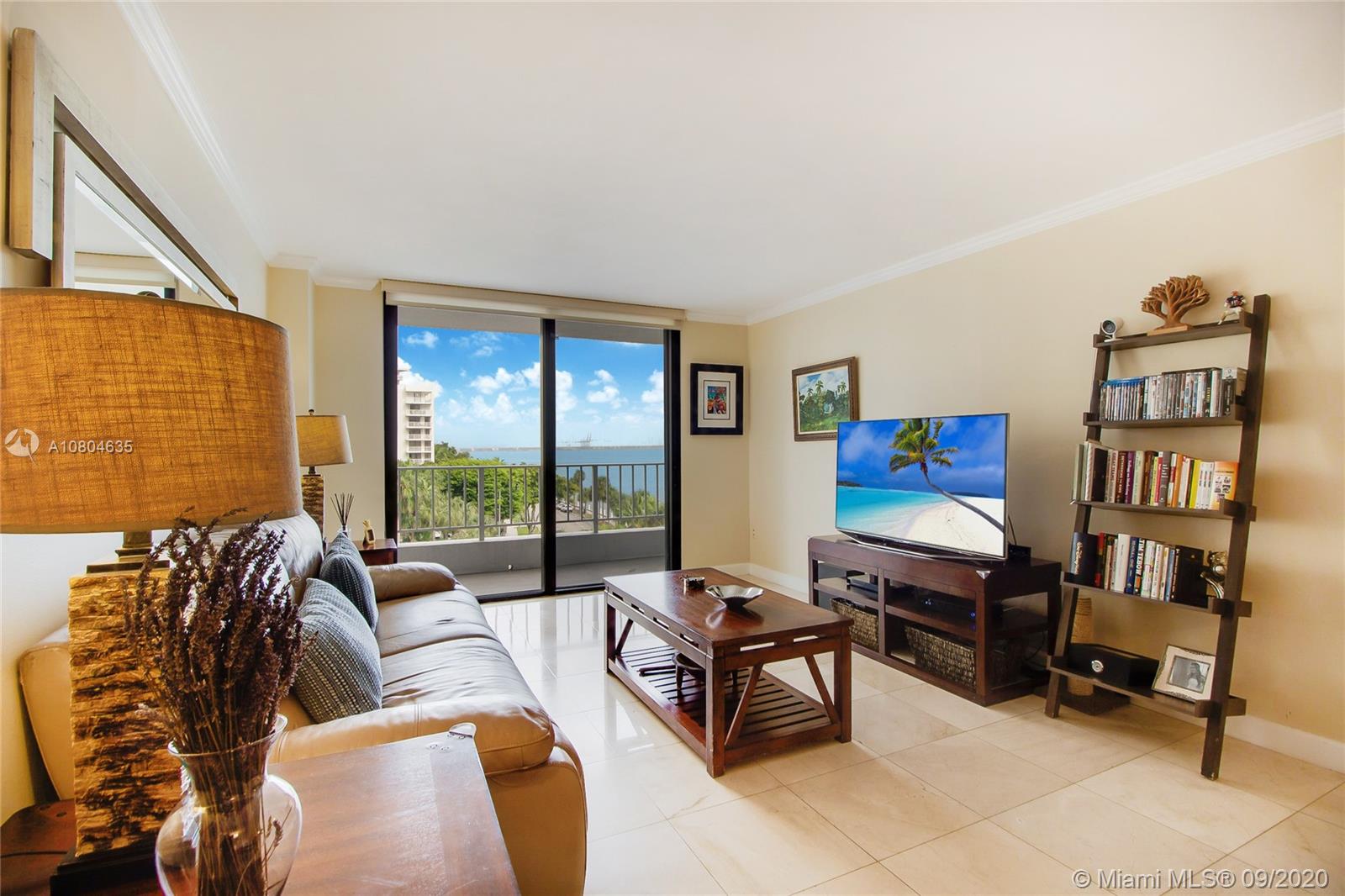 200 Southeast 15th Road, Unit 6D Miami, FL 33129 - Photo 6 of 20 a living room with furniture a flat screen tv and a floor to ceiling window