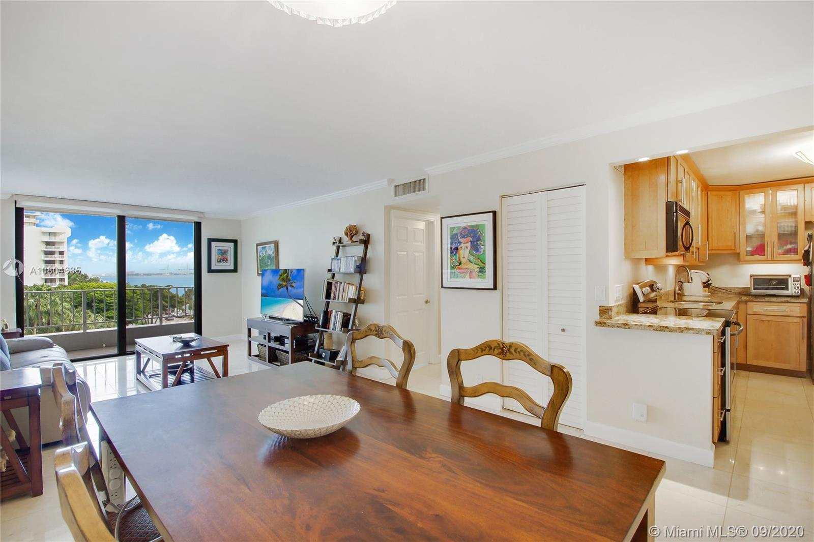 200 Southeast 15th Road, Unit 6D Miami, FL 33129 - Photo 9 of 20 a living room with furniture and a dining table with garden view