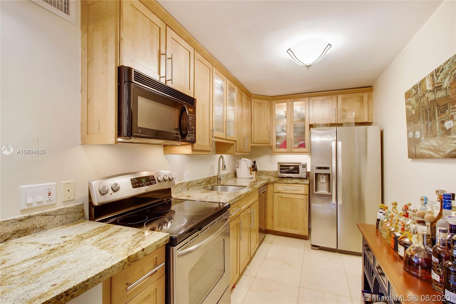 200 Southeast 15th Road, Unit 6D Miami, FL 33129 - Photo 10 of 20 a kitchen with a refrigerator stove and microwave