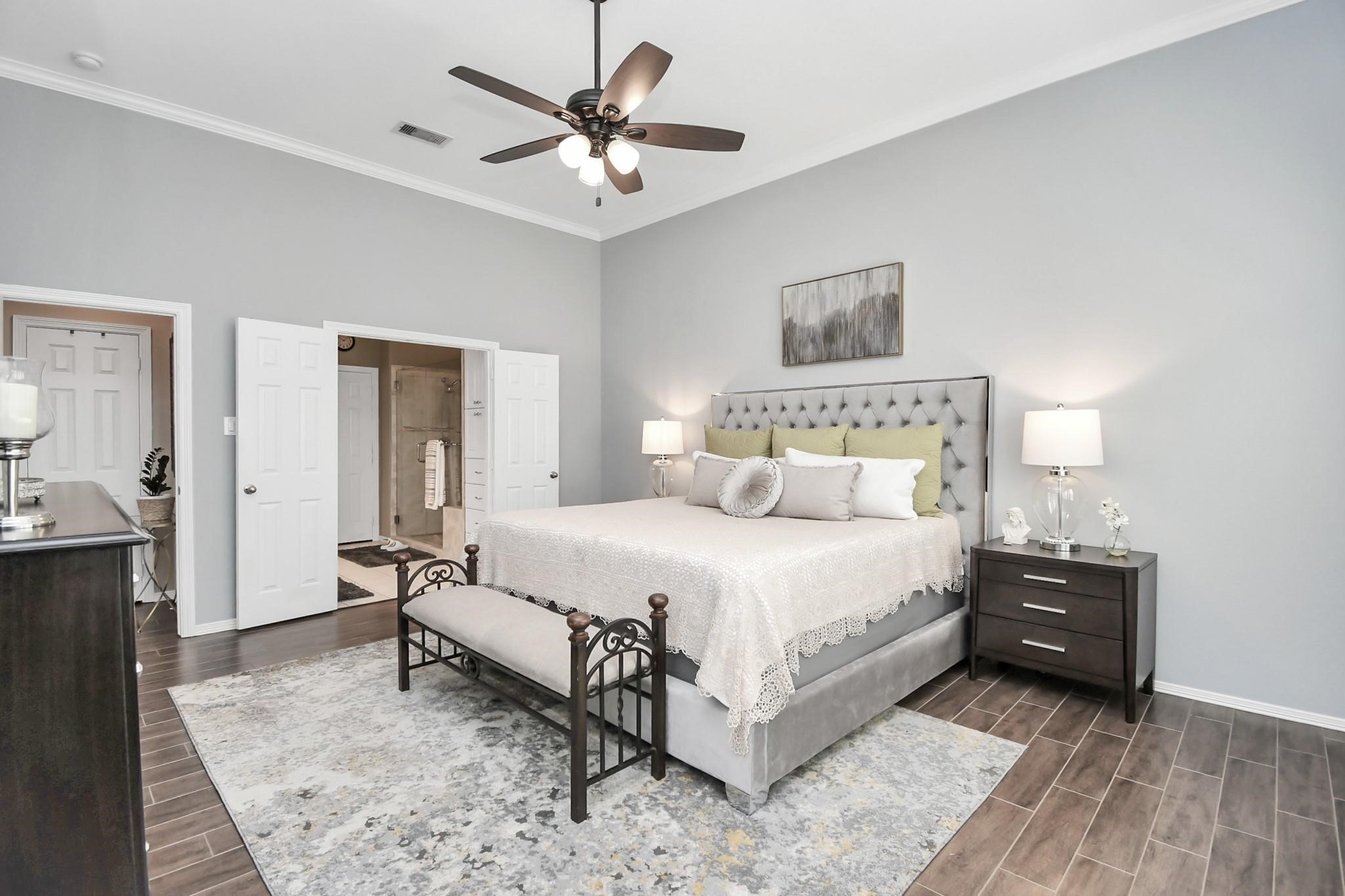 8624 Sunset Loch Drive Spring, TX 77379 - Photo 18 of 44 a bedroom with a bed and a chandelier