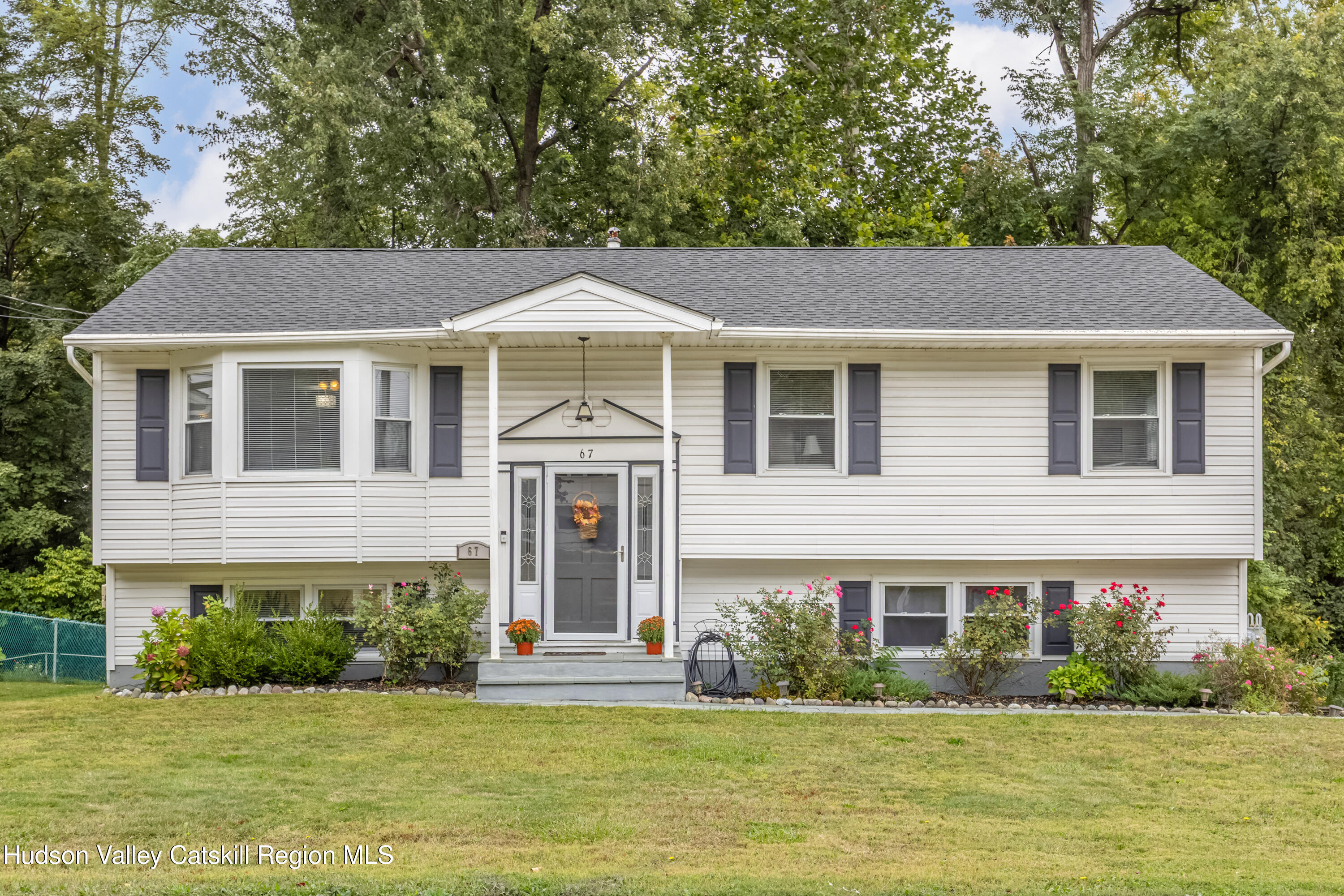 67 Cardinal Drive Poughkeepsie, NY 12601 - Photo 1 of 31 a front view of a house with a yard