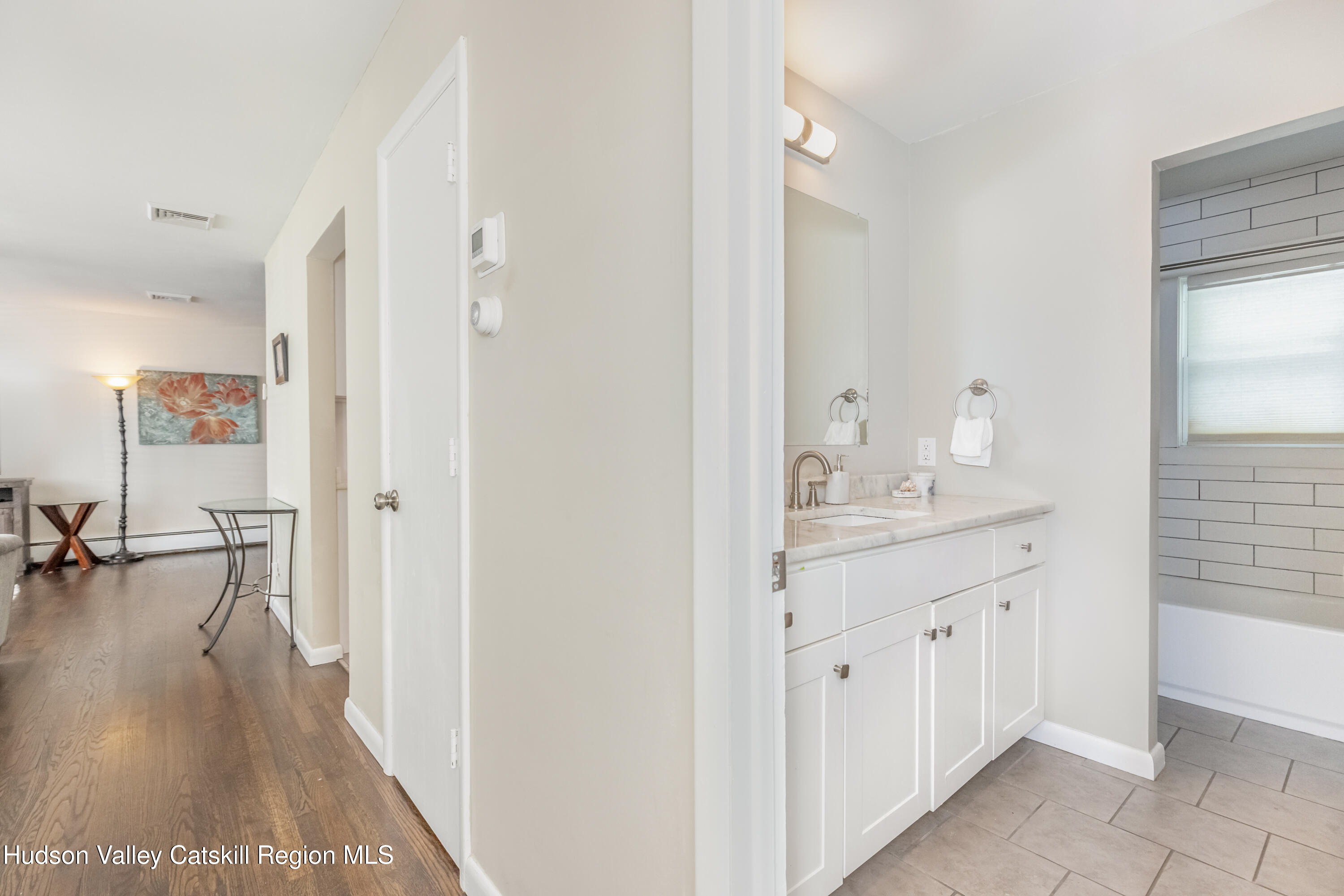 67 Cardinal Drive Poughkeepsie, NY 12601 - Photo 23 of 31 a bathroom with a sink a mirror and a shower