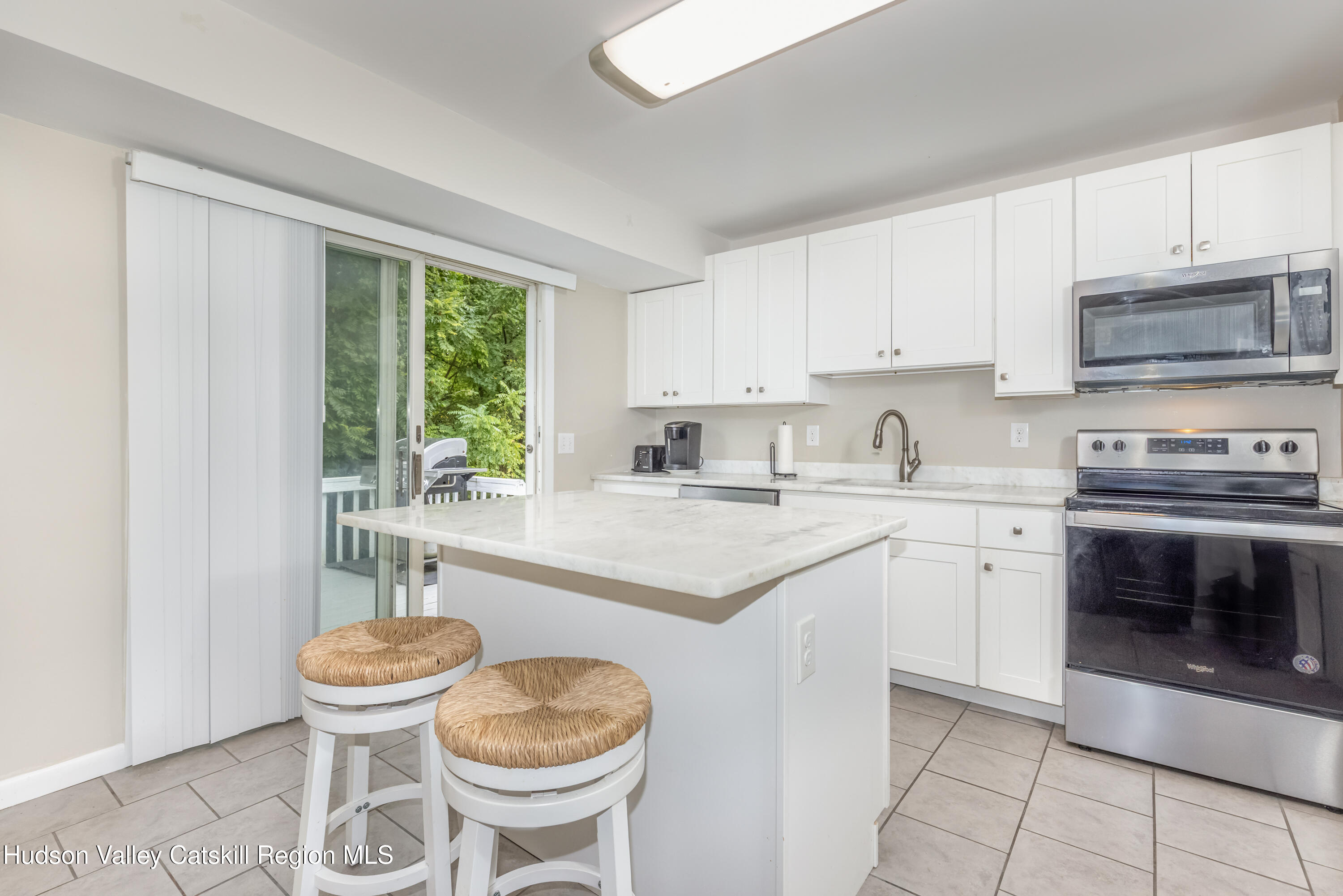 67 Cardinal Drive Poughkeepsie, NY 12601 - Photo 10 of 31 a kitchen with a stove a sink and a refrigerator