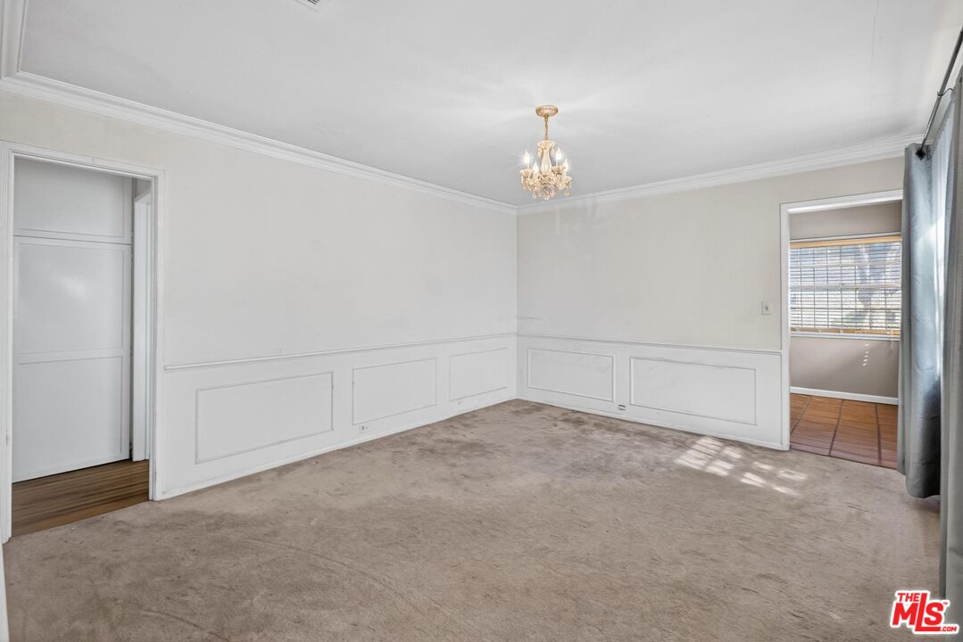 3692 Buckingham Road Los Angeles, CA 90016 - Photo 14 of 40 an empty room with a empty space and chandelier