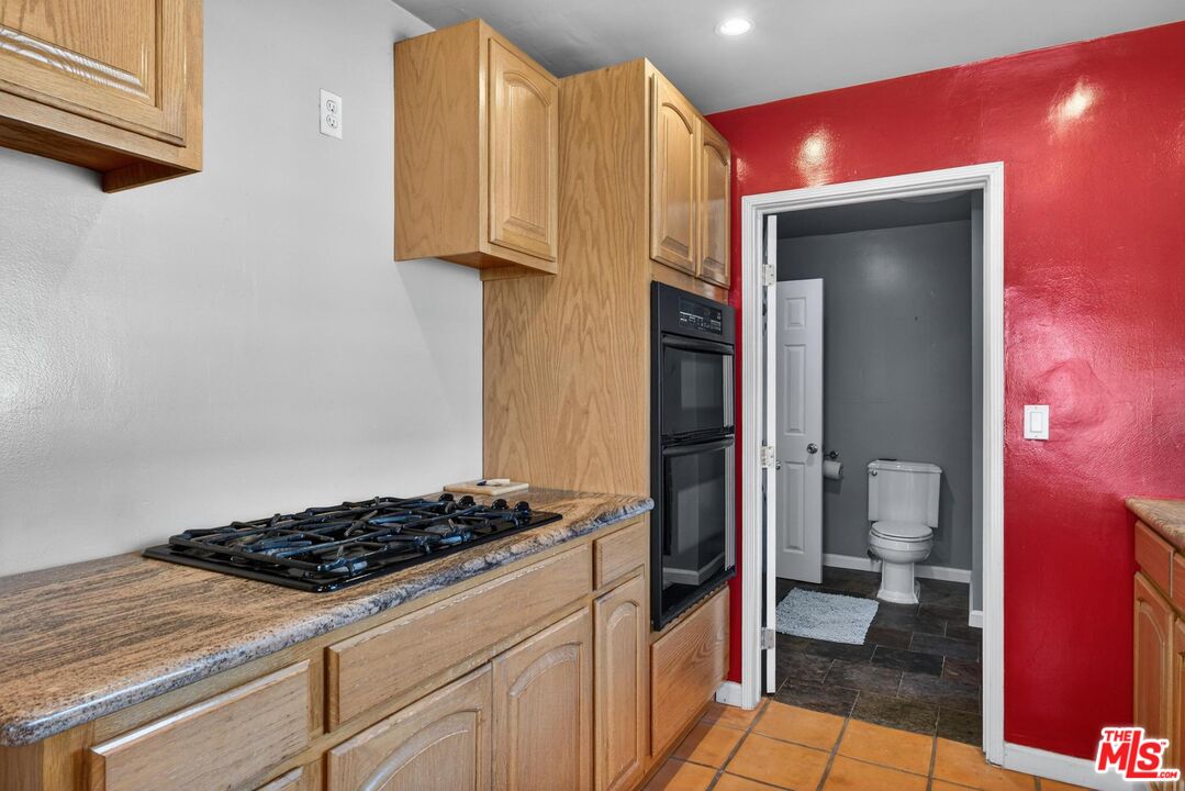3692 Buckingham Road Los Angeles, CA 90016 - Photo 23 of 40 a kitchen with a stove and a refrigerator