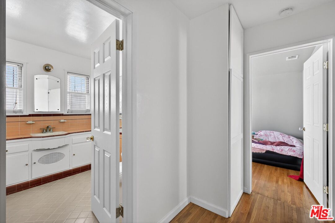 3692 Buckingham Road Los Angeles, CA 90016 - Photo 29 of 40 a bathroom with a sink and a mirror