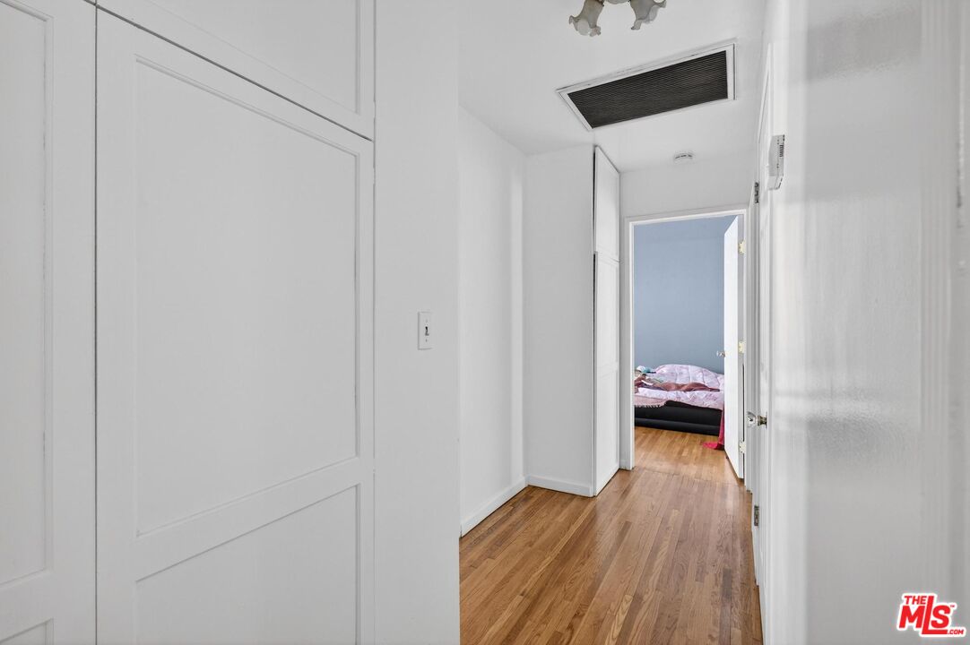 3692 Buckingham Road Los Angeles, CA 90016 - Photo 31 of 40 a room with a bed and wooden floor