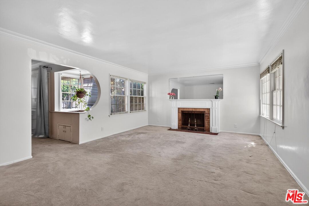 3692 Buckingham Road Los Angeles, CA 90016 - Photo 9 of 40 a view of an empty room with window and fireplace