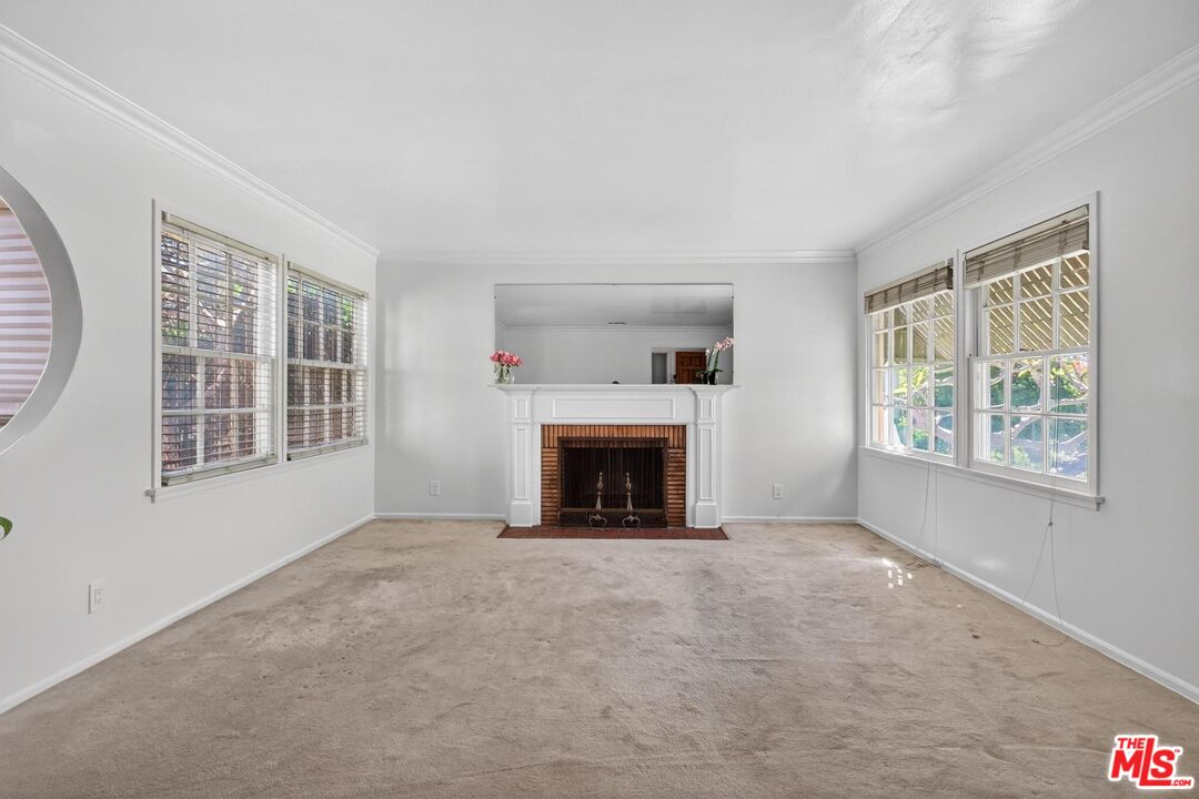 3692 Buckingham Road Los Angeles, CA 90016 - Photo 10 of 40 a view of an empty room with window and fire place