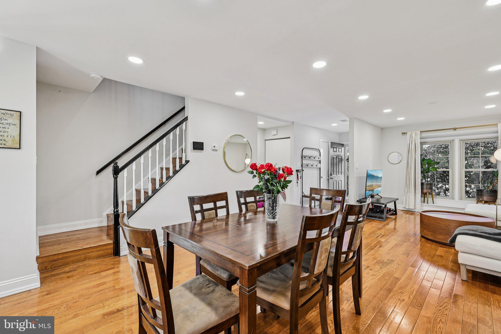 10616 Pennydog Lane Silver Spring, MD 20902 - Photo 11 of 58 a dining room with furniture potted plants and wooden floor