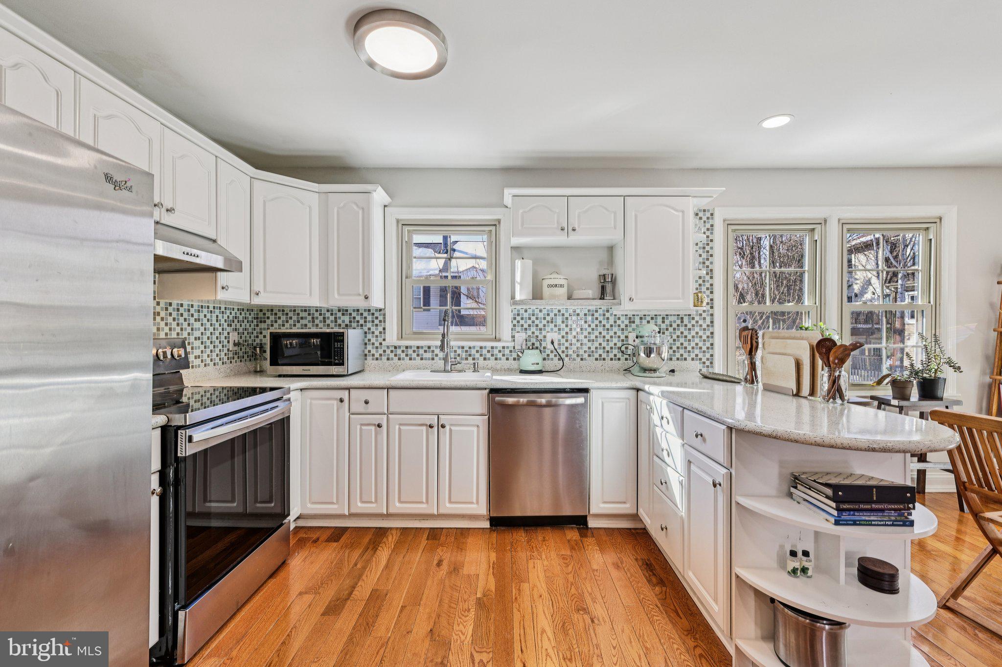 10616 Pennydog Lane Silver Spring, MD 20902 - Photo 12 of 58 a kitchen with stainless steel appliances granite countertop a stove a sink dishwasher and a refrigerator