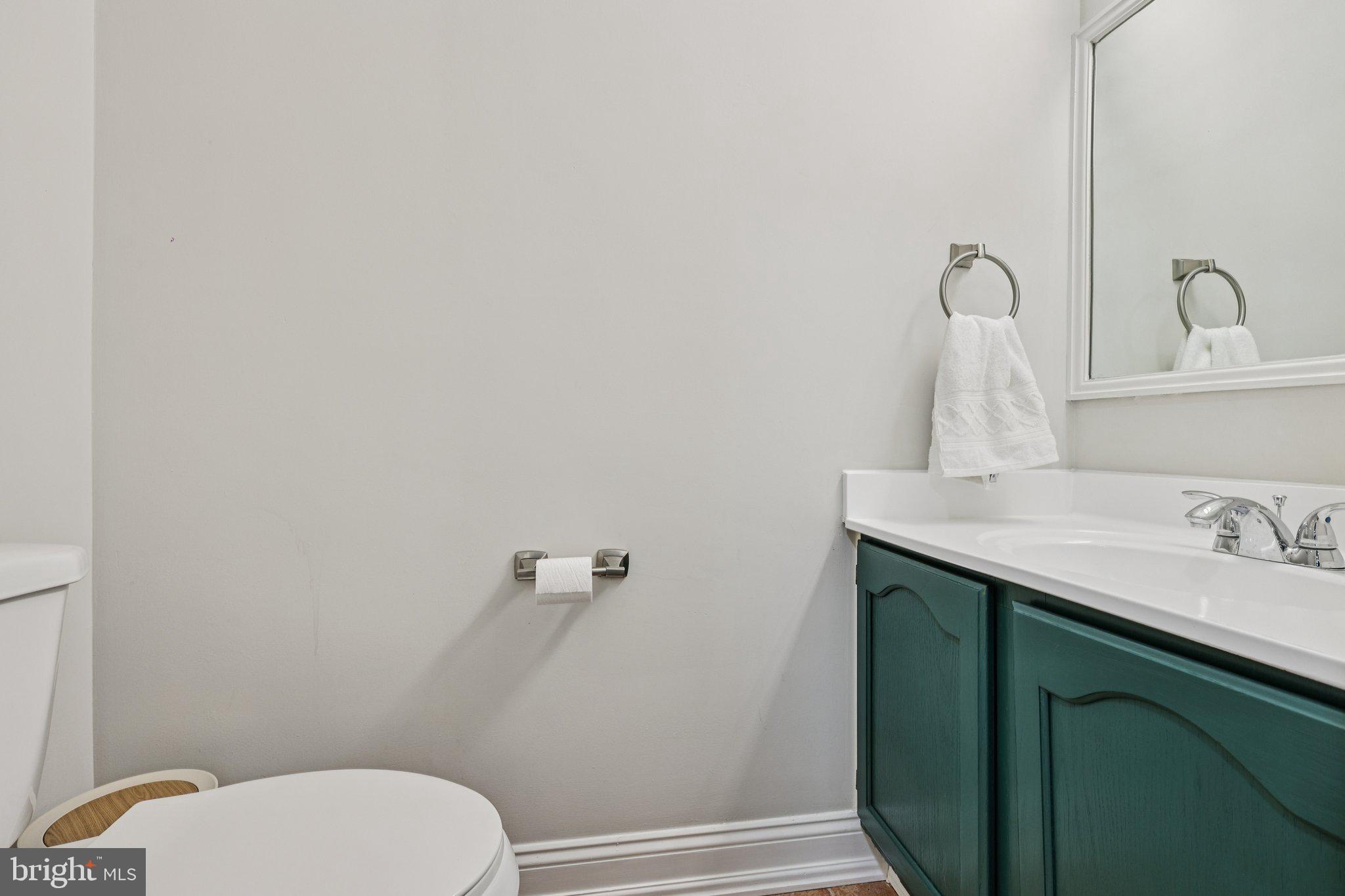 10616 Pennydog Lane Silver Spring, MD 20902 - Photo 15 of 58 a bathroom with a granite countertop toilet sink and mirror